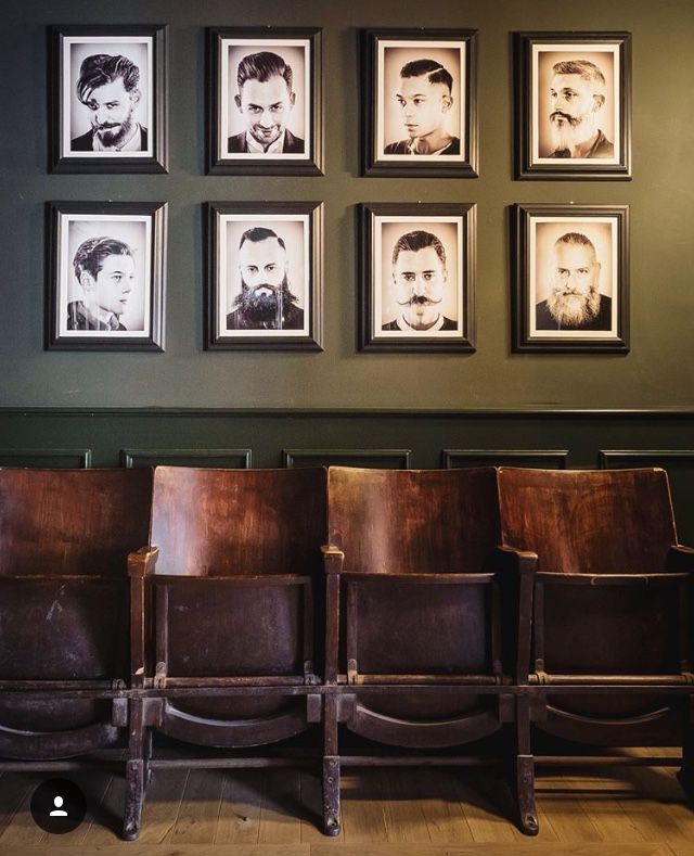 Wall of framed sepia gentleman portraits at Vintage Blade