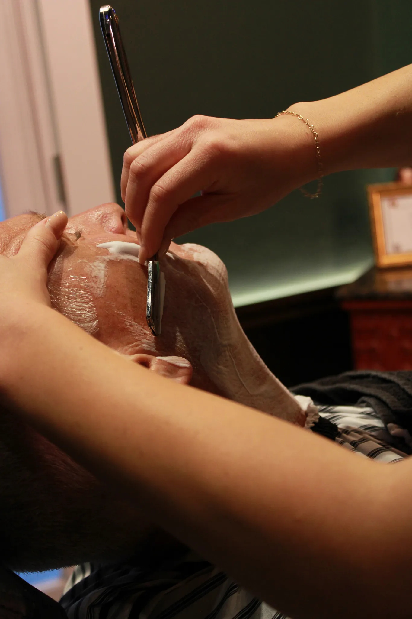 The barber chair and green styling room at Vintage Blade